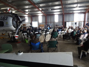 Attendees listening to a presentation in the hangar